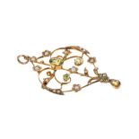 Edwardian peridot and seed pearl pendant brooch with openwork foliate scrolls, 54mm