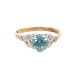 Blue zircon and diamond ring with a round mixed cut blue zircon measuring approximately 6.7mm in pla