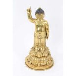 Oriental gilt bronze figure of buddha on a double lotus base