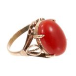 Coral dress ring with an oval coral cabochon measuring approximately 16.2mm x 11.4mm in yellow metal