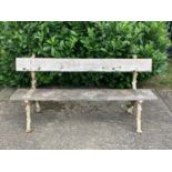 Victorian cast iron garden bench with rustic branch design and wooden slats