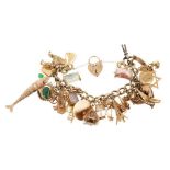 Gold charm bracelet with an extensive collection of 9ct gold charms.