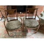 Pair of Edwardian satinwood and polychrome painted elbow chairs, each with tablet back and stuffover