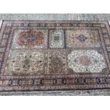 Kashmir hand knotted part silk rug, with foliate rectangular reserves, within conforming border with