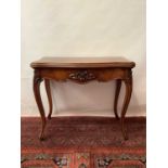 Victorian figured walnut veneered card table with serpentine front, carved floral frieze on cabriole