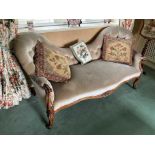 Victorian two seater settee, with undulating button upholstered back and seat and floral carved waln