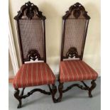 Pair of William and Mary style walnut and caned high back side chairs, each with shell cresting and