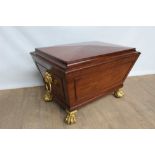 Fine Regency mahogany wine cooler of sarcophagus form with ormolu paw feet