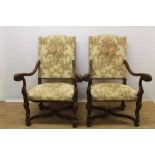 Pair of Carolean style carved walnut open armchairs, with arched pad back and seat and scrolled arms