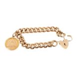 A heavy 9ct gold curb link bracelet with padlock clasp and gold fob.