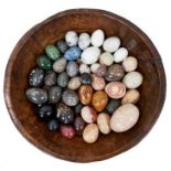 Collection of forty-five specimen stone eggs, in antique treen bowl