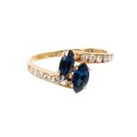 Cartier sapphire and diamond cross-over ring with two marquise cut blue sapphires in a cross-over de