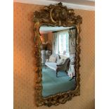 Early 18th century style pierced gilt gesso wall mirror, shaped plate within pieced c-scroll frame w
