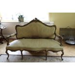 19th century French giltwood sofa upholstered in gold damask with rococo scroll cresting, padded ope