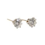 Pair of diamond single stone stud earrings, each with an old cut diamond in claw setting, estimated