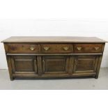 Mid 18th century oak dresser base, with three frieze drawers and fielded panel cupboard doors below