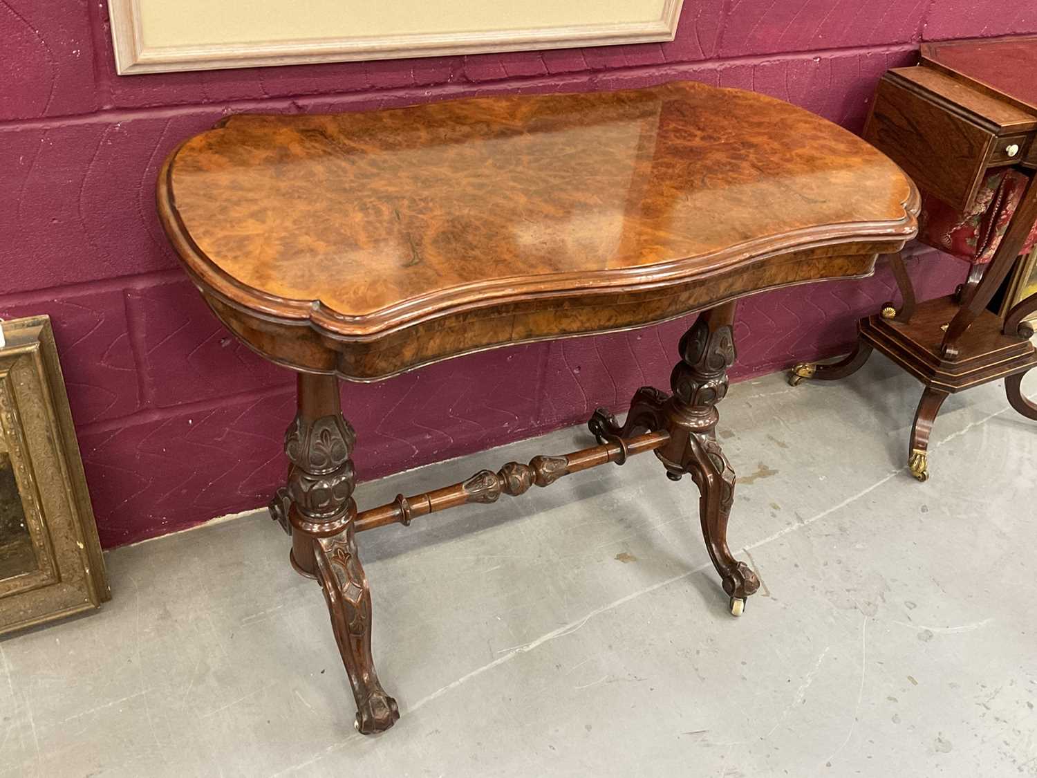 Victorian burr walnut veneered card table with shaped fold-over top on carved and turned supports wi