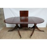 Regency style mahogany twin pillar dining table