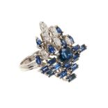 Sapphire and diamond cluster cocktail ring with mixed cut blue sapphires and six marquise cut diamon
