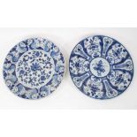 Two 18th century Dutch Delft blue and white circular dishes with foliate panels, 34cm and 35cm diame