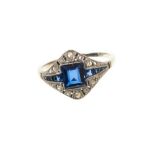 Art Deco sapphire and diamond ring with a central step cut blue sapphire flanked by tapered calibre