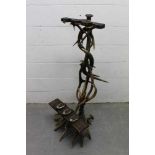 Antique Tyrolean hunting lodge worked antler gun stand, with three housings, on spread base, 134cm h