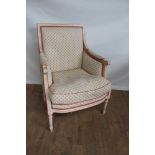 Modern upholstered arm chair with painted and carved show frame, on turned and fluted legs