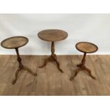 Three pedestal wine tables of graduated form with circular tops