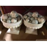 Two urns with decorative painted balls and wooden mantel clock