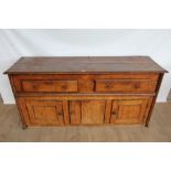 Early 18th century elm dresser base with two drawers and cupboards below