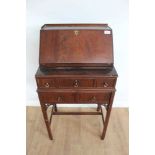 19th century-style miniature mahogany writing desk with fall front enclosing fitted interior, above