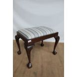 Queens-Anne style dressing stool on four cabriole legs and carved claw and ball feet
