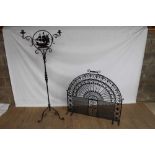 Large ornate arched wrought iron fire guard, together with a wrought iron twin branch candle stand (