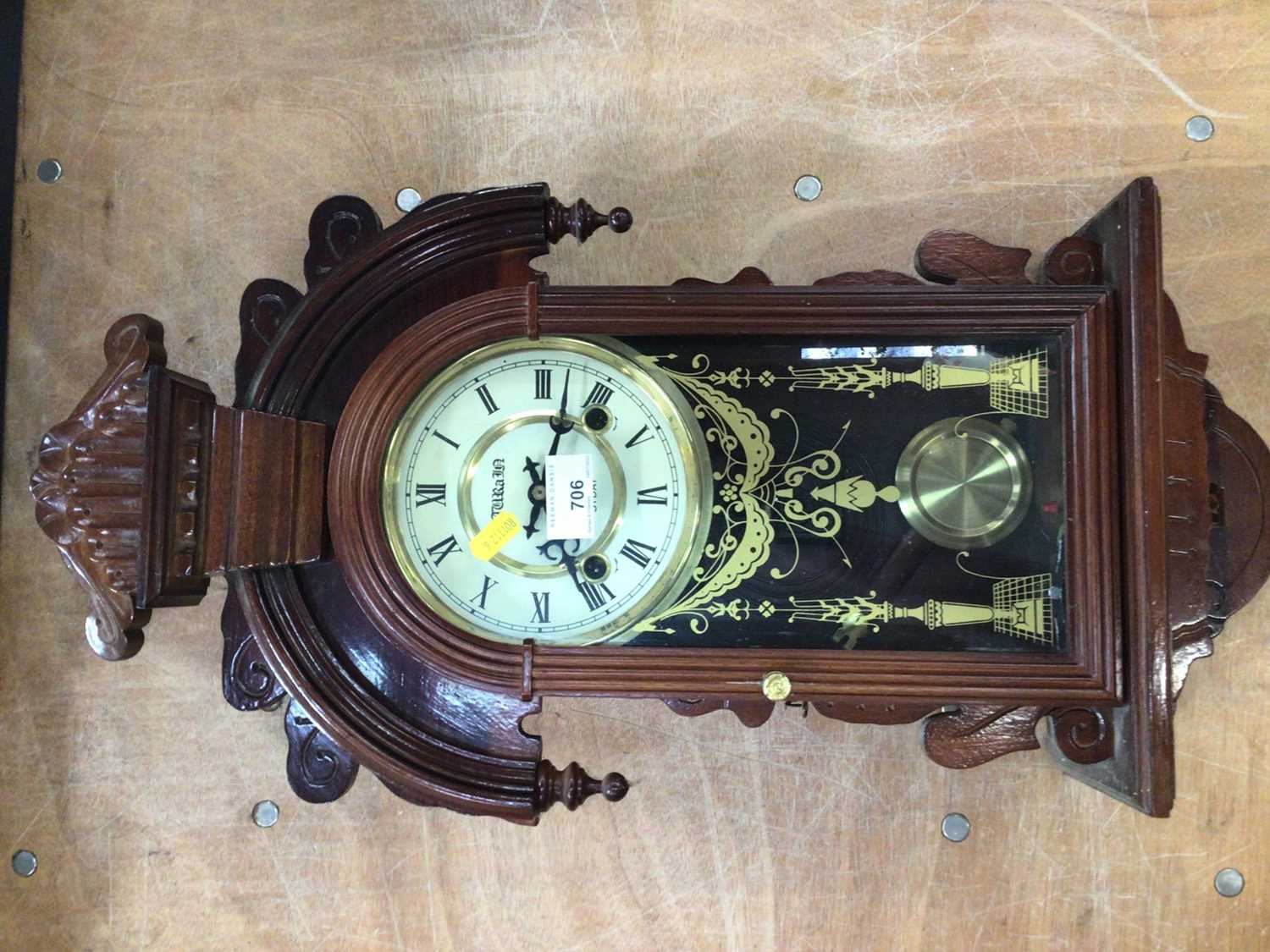 A wooden case 31 day pendulum wall clock