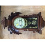 A wooden case 31 day pendulum wall clock