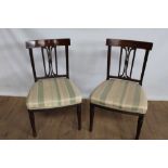 Pair of 19th century mahogany dining chairs with reeded supports and striped upholstered seats