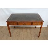 Reproduction mahogany writing table with green leather lined top and three drawers, three dummy draw