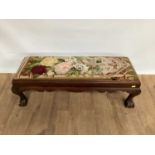 1920s long footstool with needlework top, on carved claw and ball feet