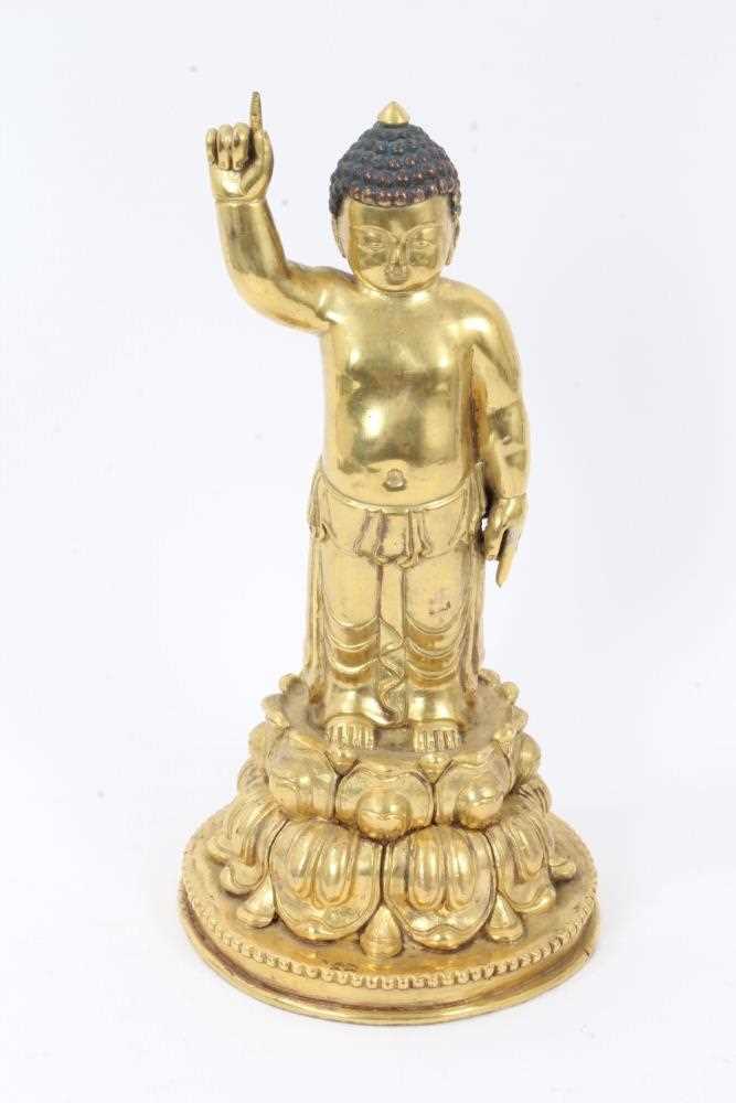 Oriental gilt bronze figure of buddha on a double lotus base