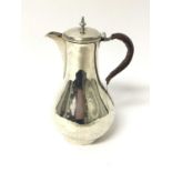 George III silver jug of baluster form, with hinged cover and leather covered handle, on a circular