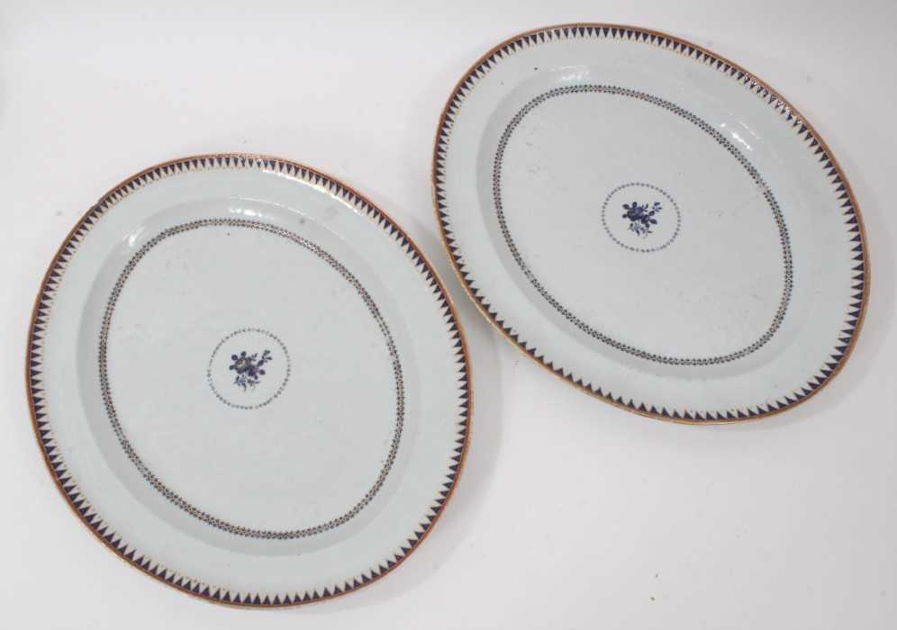 Pair of Chinese porcelain platters, circa 1800, with geometric patterns and a central floral spray,