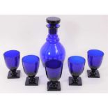 A ‘Bristol’ blue tinted glass decanter and stopper and five rummers, each on square base