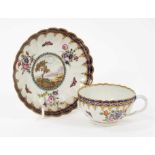 A Worcester porcelain fluted tea cup and saucer, circa 1780, of Dalhousie type, each painted with a