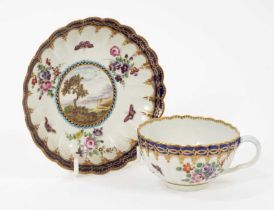 A Worcester porcelain fluted tea cup and saucer, circa 1780, of Dalhousie type, each painted with a