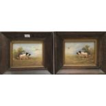 Pair of early 20th century Crown Devon hand painted pottery wall plaques depicting spaniels chasing