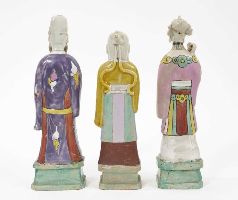 Three Chinese porcelain figures of immortals, Qianlong period, each polychrome decorated and shown s - Image 2 of 9