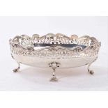 Edwardian silver dish of oval form, with decorative pierced border on four scroll feet