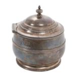 George V silver tea caddy of cauldron form with central band of reeded decoration, hinged domed cove
