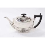 1920s silver teapot of half fluted form with hinged domed cover and angular Ebony handle