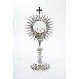 18th / 19th century Continental silver monstrance of typical sun burst form, raised on knopped colum